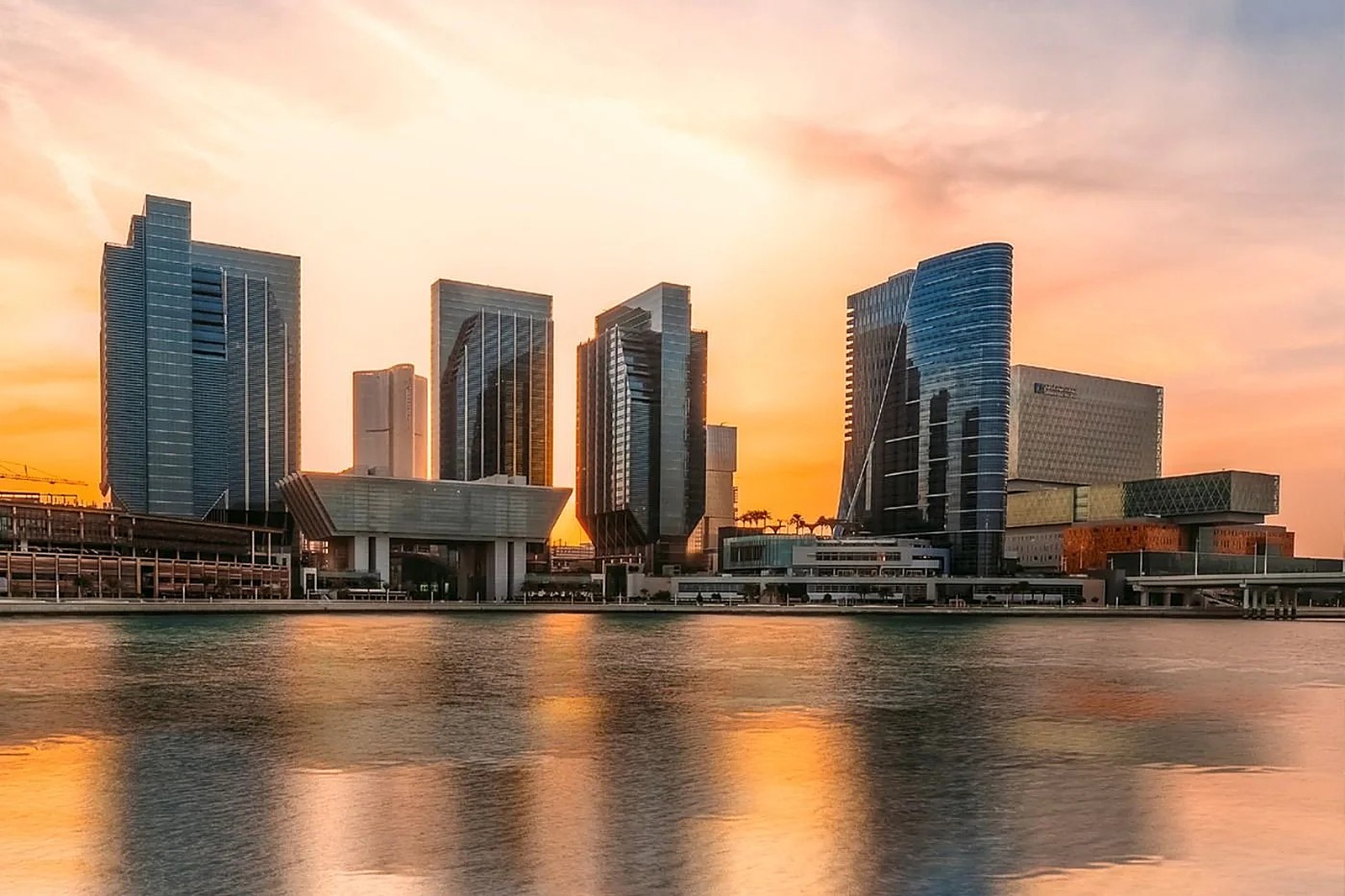 Al Maryah Island skyline reflected at night with fireworks